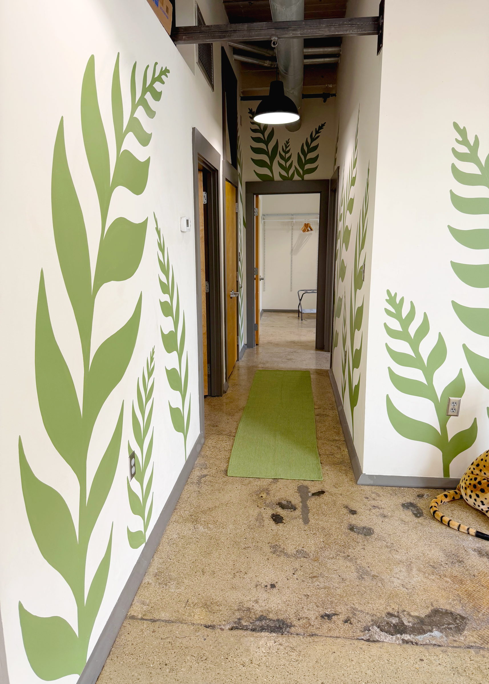 Fern leaf mural along a hallway at JFG Flats, the historic JFG Coffee building in Knoxville